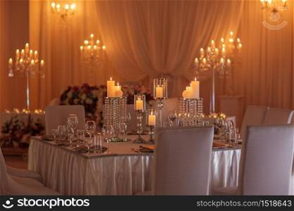 Wedding hall decoration with crystal chandeliers and candles.. Wedding hall decoration with crystal chandeliers and candles
