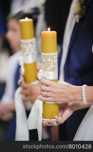 Wedding handmade decorations at restaurant. Lighting candle on wedding reception