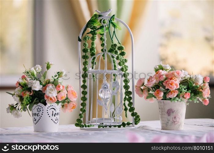 Wedding handmade decorations at restaurant with all beauty and flowers.. Wedding decorations bird cage at restaurant with all beauty and flowers