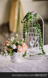 Wedding handmade decorations at restaurant with all beauty and flowers.. Wedding decorations bird cage at restaurant with all beauty and flowers