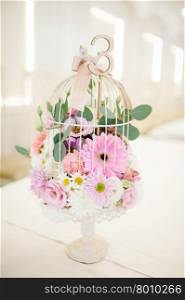 Wedding handmade decorations at restaurant with all beauty and flowers.. Wedding bird cage decorations at restaurant with all beauty and flowers