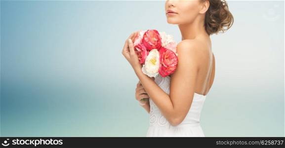 wedding, holidays, people and celebration concept- bride or woman with bouquet of flowers over blue background