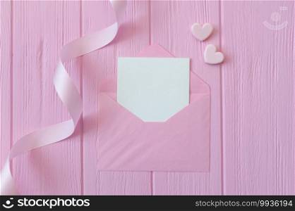 Wedding or birthday mock up scene. Blank open envelope with place for text for greeting card copyspace. Valentines card with two hearts on pink background. Flat lay, top view.. Wedding or birthday mock up scene. Blank open envelope with place for text for greeting card copyspace. Valentines card with two hearts on pink background. Flat lay, top view