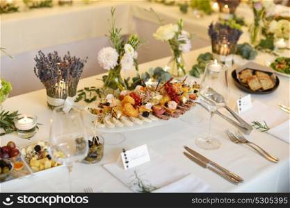 Wedding reception place ready for guests. table with food and drink