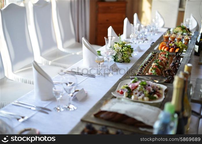 Wedding reception place ready for guests. table with food and drink