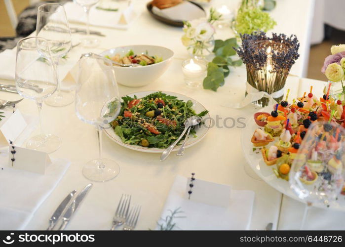 Wedding reception place ready for guests. table with food and drink