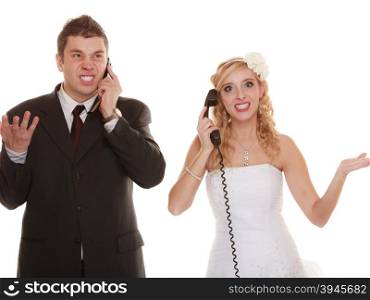 Wedding relationship difficulties. Angry woman and fury man talking on phone. Couple bride groom quarrelling screaming isolated on white.