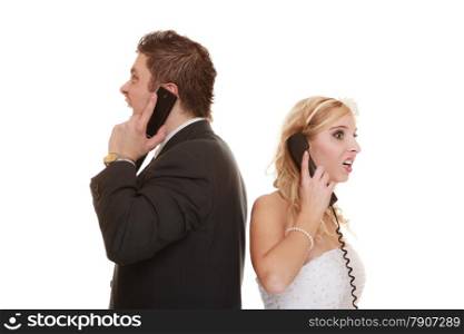 Wedding relationship difficulties. Angry woman and fury man talking on phone. Couple bride groom quarrelling screaming isolated on white.