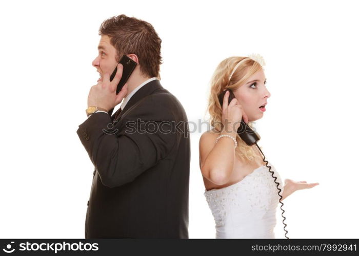 Wedding relationship difficulties. Angry woman and fury man talking on phone. Couple bride groom quarrelling screaming isolated on white.