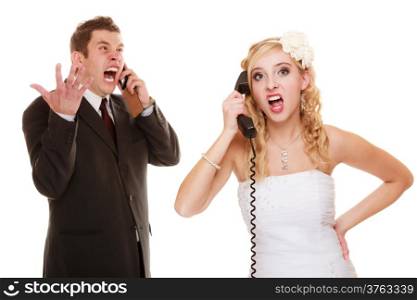 Wedding relationship difficulties. Angry woman and fury man talking on the phone. Couple bride and groom quarrelling screaming isolated on white.