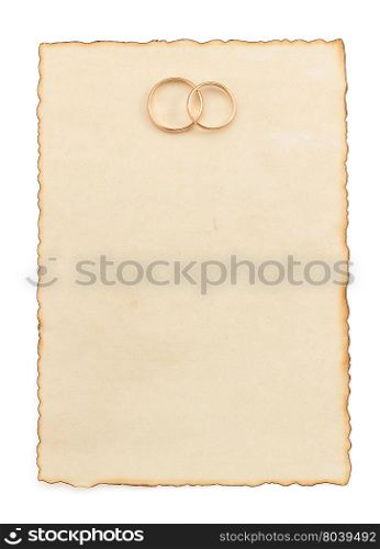 wedding ring and aged paper isolated on white background