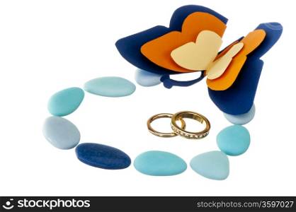 wedding ring and weddings favors on white background