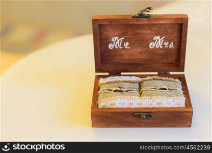wedding ring pillow burlap in wooden box monogrammed on the table