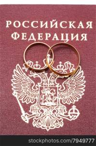wedding rings and a Russian passport on white background