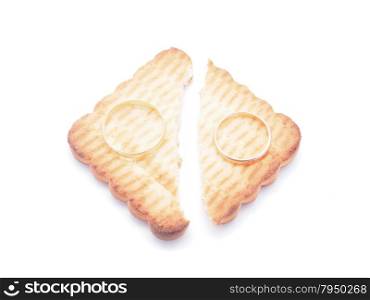 wedding rings and cookies on a white background