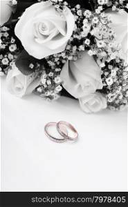 wedding rings and roses bouquet