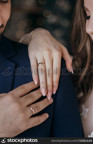 Wedding rings B W. Hands of bride and groom with rings.