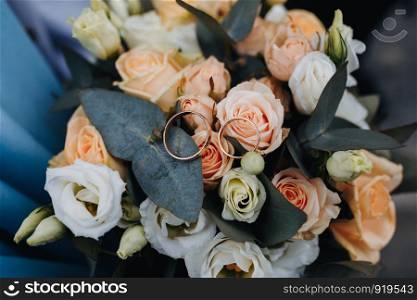 wedding rings in a bouquet of the bride. bouquet of roses. wedding rings in a bouquet of the bride. bouquet of roses.