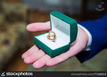 wedding rings in a box holding the groom. ring in a box