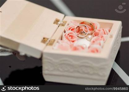 Wedding rings in a white casket. With flowers. Wedding rings in white casket. With flowers