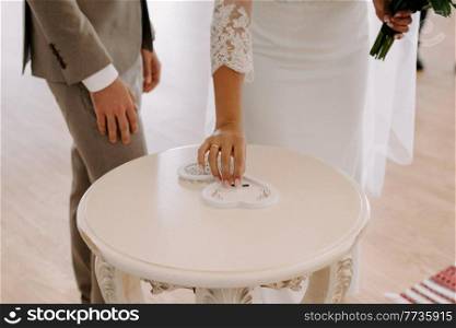 wedding rings in wood carved heart-shaped box