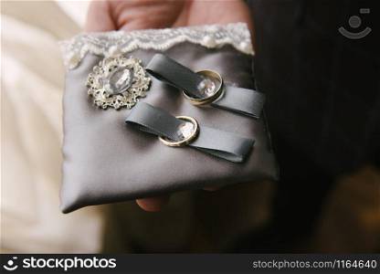 Wedding rings lie on a cushion for wedding rings.. Wedding rings lie on a cushion for wedding rings close up