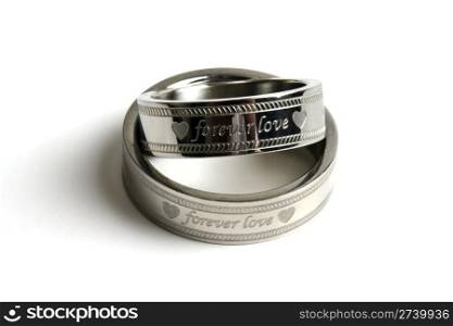 Wedding rings of Forever Love isolated on white