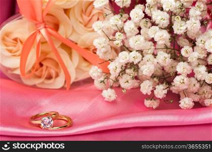 wedding rings on a colorful fabric background