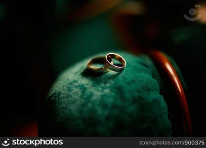 wedding rings on a green velvet. two gold wedding rings. wedding rings on a green velvet. two gold wedding rings.