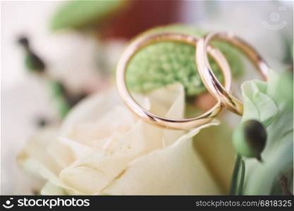 Wedding rings on beautiful flowers. Macro shot