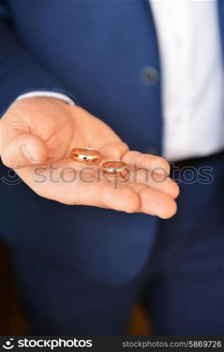 Wedding rings on palm of groom