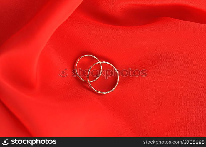 wedding rings on red background