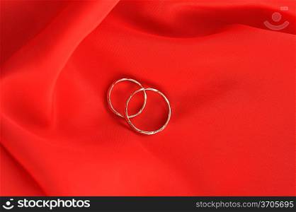 wedding rings on red background
