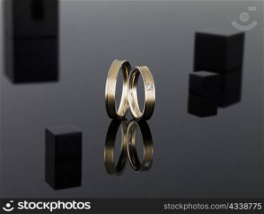 Wedding rings on reflective surface