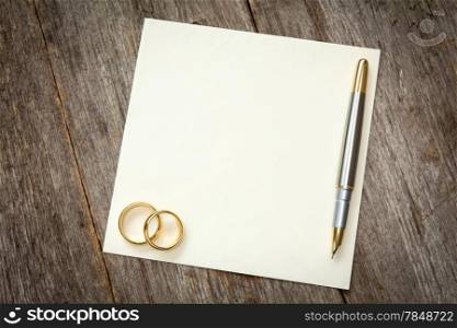 Wedding rings on the empty card for your text
