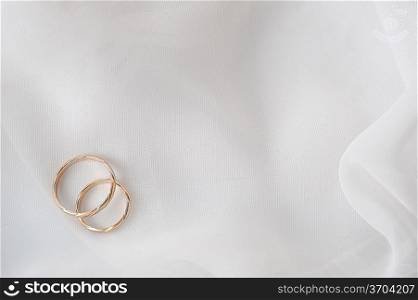 wedding rings on white material