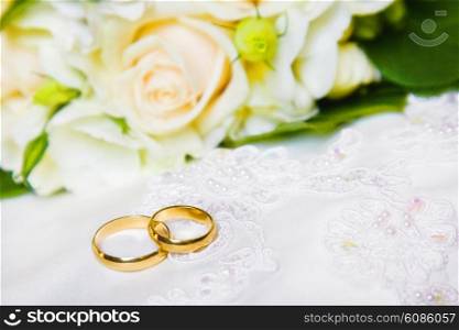 wedding rings with bouquet from roses with a shallow DOF
