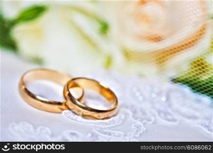 wedding rings with bouquet from roses with a shallow DOF