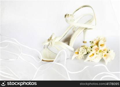 wedding sandals and flowers decoration over bridal veil