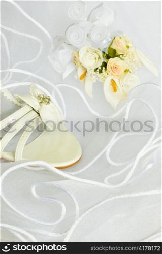 wedding sandals and flowers decoration over bridal veil