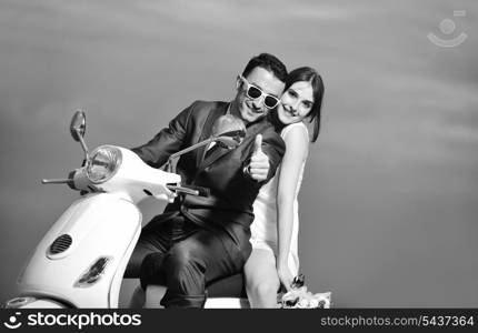 wedding sce of bride and groom just married couple on the beach ride white scooter and have fun