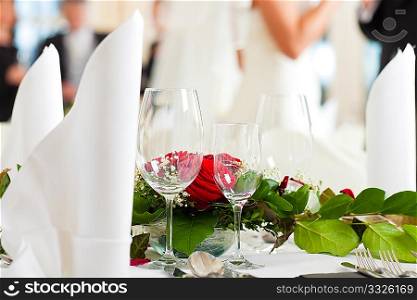 Wedding table at a wedding feast decorated with flowers