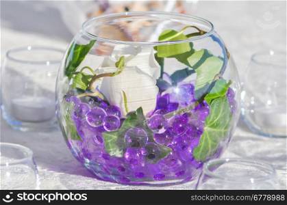 wedding table decor with purple marbles and white rose
