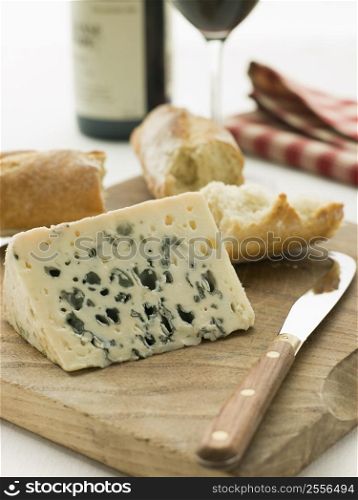 Wedge of Roquefort Cheese with Rustic Baguette and Red Wine