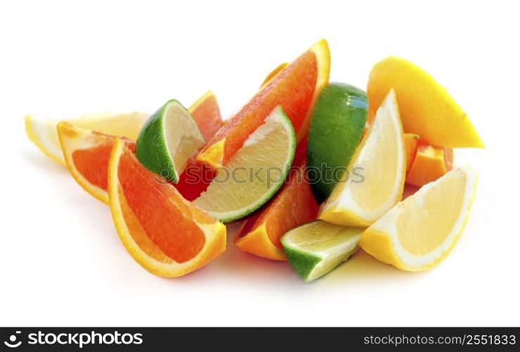 Wedges of assorted citrus fruits isolated on white background