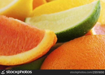 Wedges of assorted citrus fruits lemon orange and lime