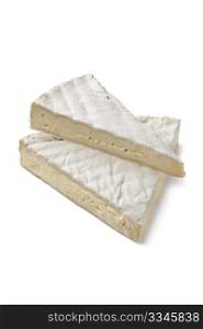 Wedges of French Brie cheese on white background
