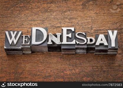 Wednesday word in mixed vintage metal type printing blocks over grunge wood