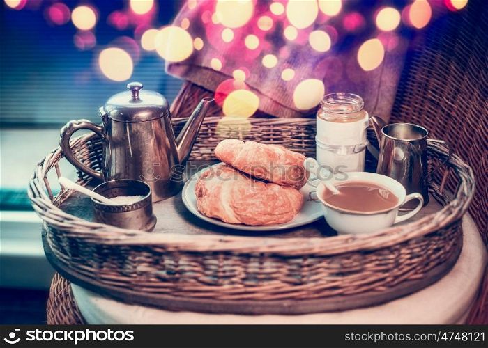 Weekend breakfast with vintage coffee pot and croissants, mug of coffee and bokeh