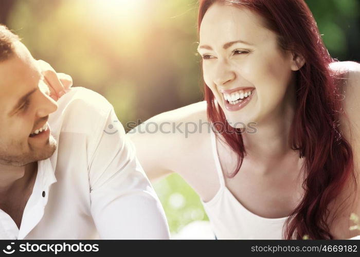 Weekend in park. Young couple in love having fun and enjoying the beautiful nature